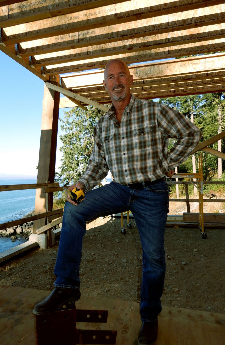 a photo of custom builder Owen Poppy owner and chief bottle washer, standing in a new home in progress at surfside construction inc.