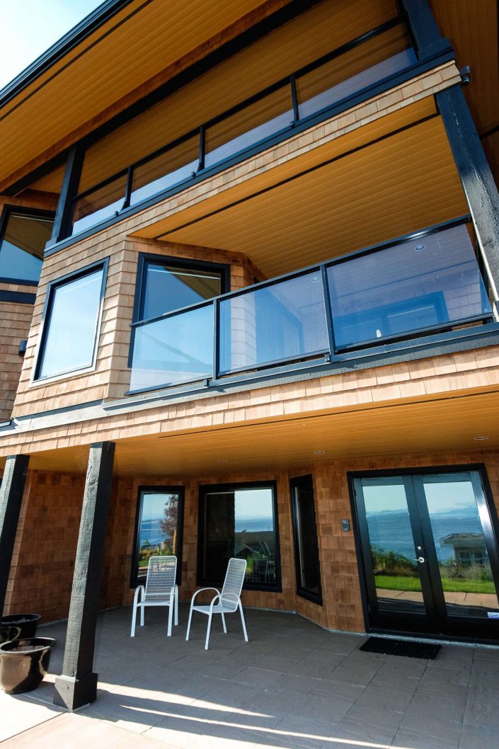 A photo of the exterior of the sunset view home in white rock bc showing the large decks as built by surfside construction inc.