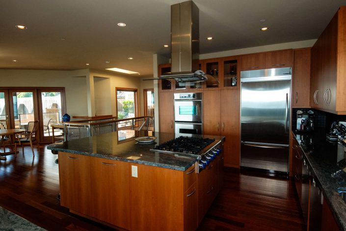 Another image of the kitchen looking out into the dining are of the sunset view home as built by surfside construction inc.