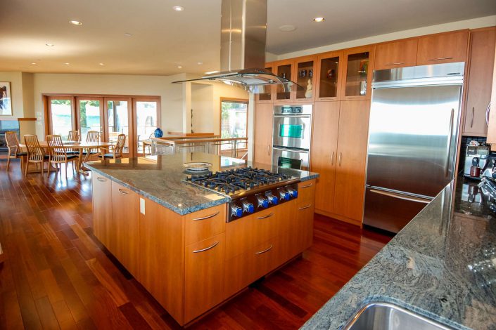 A interior image of the large kitchen, island and cook top in the sunset view home in white rock bc as built by surfside construction inc.