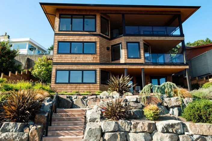 A photo from the street of the sunset view home showing the three stories and decks as built by surfside construction inc.