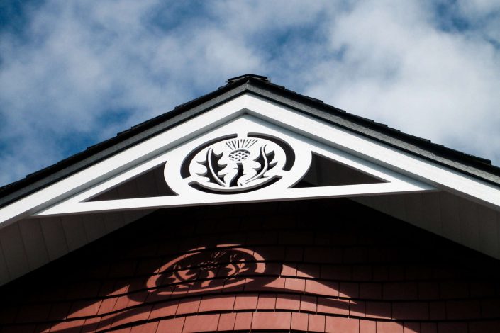 a photograph of one of the peaks of the shingle style estate home. as built by surfside construction inc.