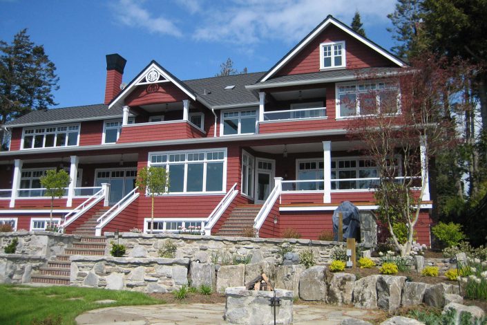 A photo of a shingle-style estate showing the back of the home.