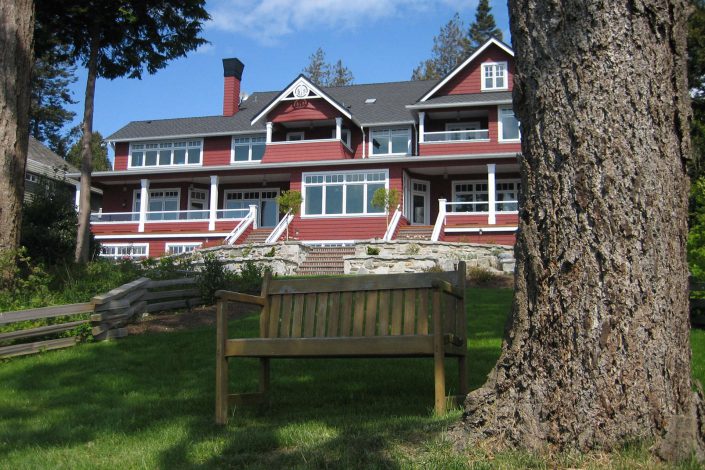 A photo of a shingle-style estate showing the back of the home.