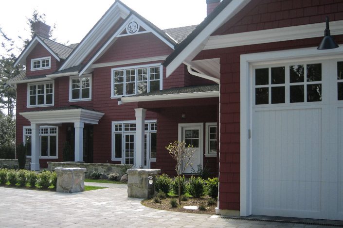A photo of a shingle-style estate showing the front of the home.