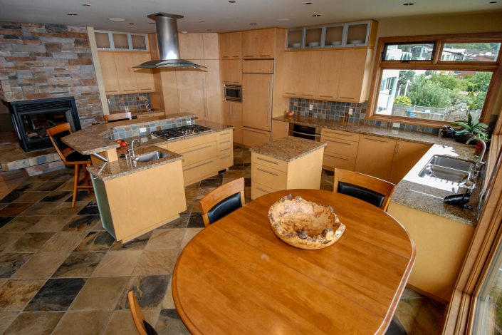 A photo of the kitchen from a different angle of a cedar style estate home built by Surfside Construction.