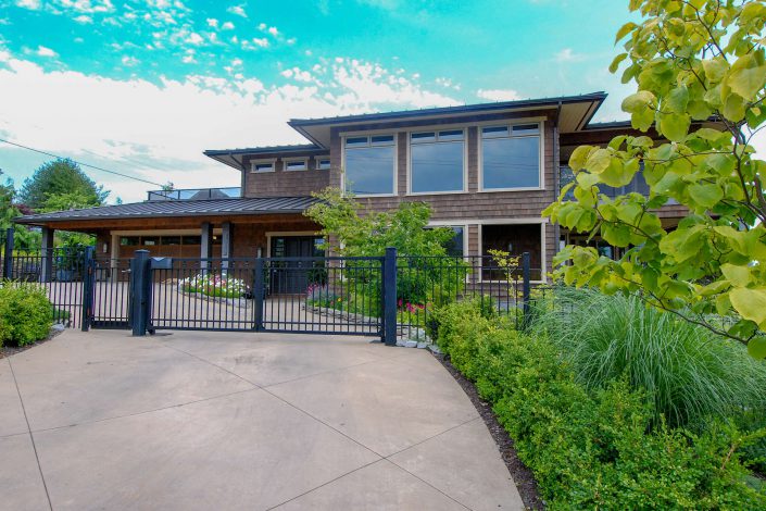 A photo of the front of a cedar shake hill side estate from another angle built by Surfside Construction.