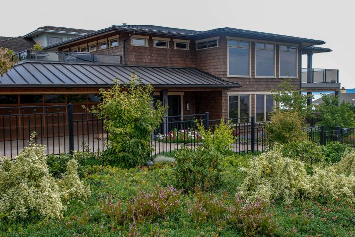 A photo of the front of a cedar shake hill side estate from another angle built by Surfside Construction.