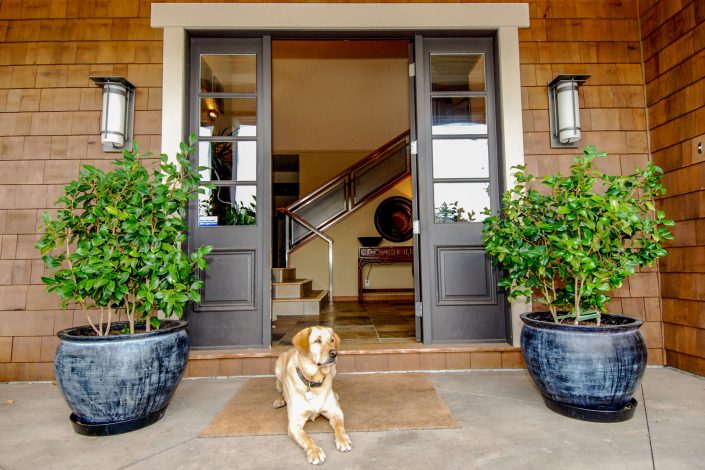A photo of the front entrance of a cedar style home built by surfside construction.