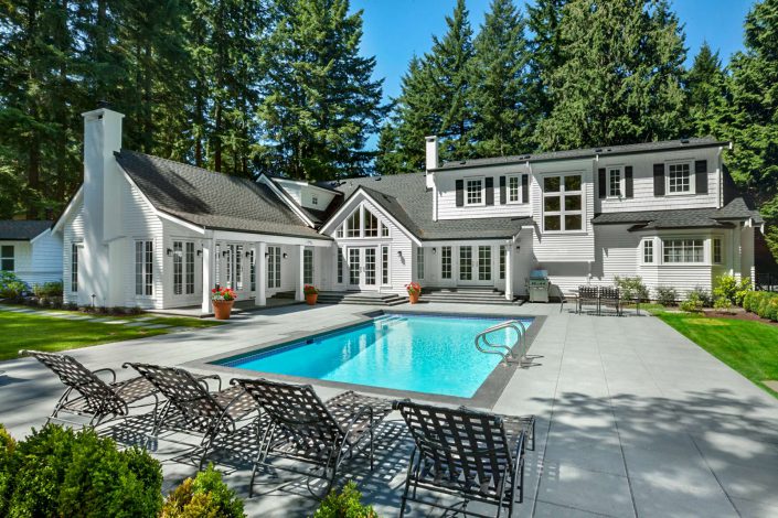 A photo showing the backyard, pool and landscaping of the country classic home built by surfside construction inc.