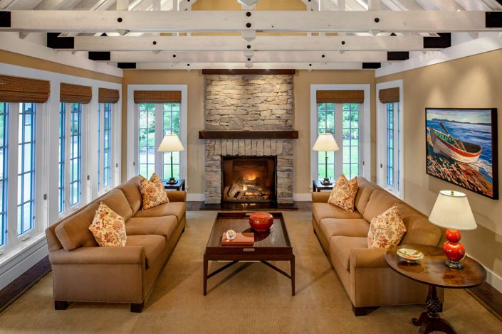 A photo showing the beamed ceiling and living room of the country classic home built by surfside construction inc.