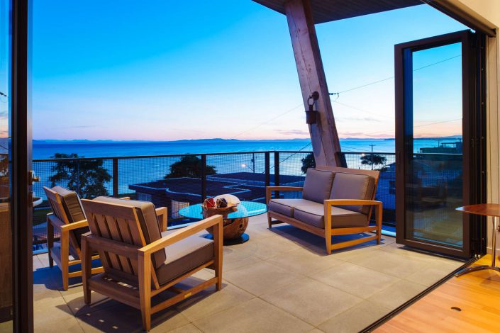 a photograph of the seating area on the main deck off the living room in the west beach home as built by surfside construction inc.