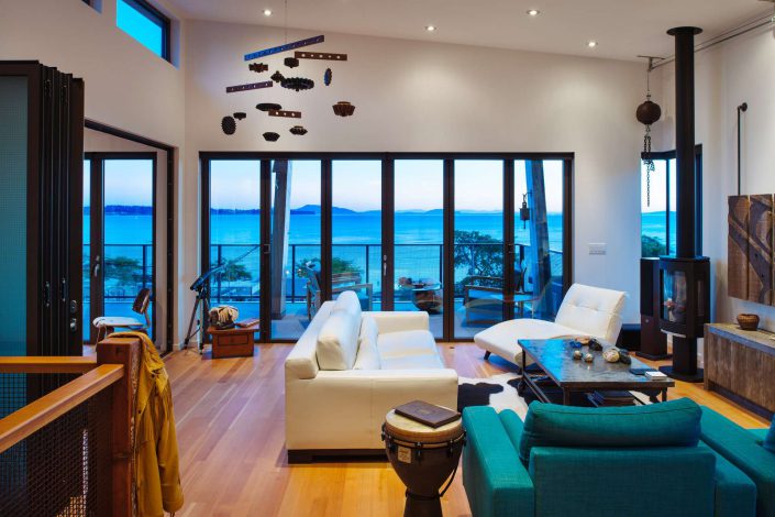 a photograph of the interior living space looking out to the ocean of the west beach home built by surfside construction inc.
