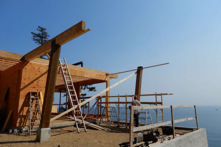 A photo of the large beams in place at the lighthouse home in the sooke bc as built by surfside construction inc.