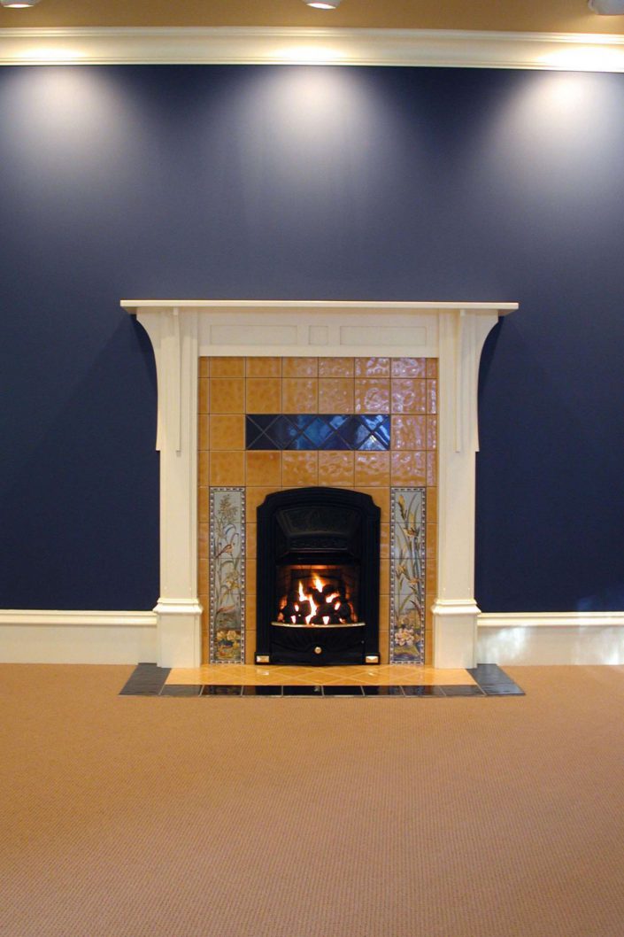 A photo of the master bedroom fireplace and tile work of the victorian replica home as built by surfside construction inc.