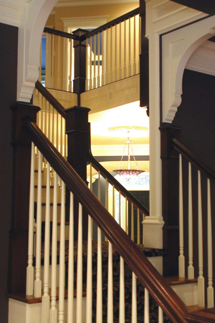 A photo of the wood stair case of the victorian replica home as built by surfside construction inc.