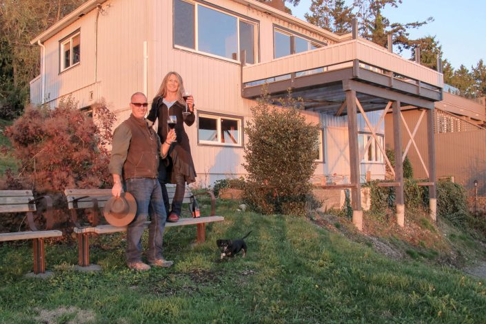 A photo of Owen and Shauna Poppy toasting to the start of the West beach build in white rock bc.