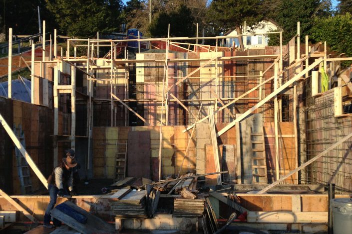 A photo from the alley at the west beach home in white rock bc showing the extensive foundation framing required as built by surfside construction inc.