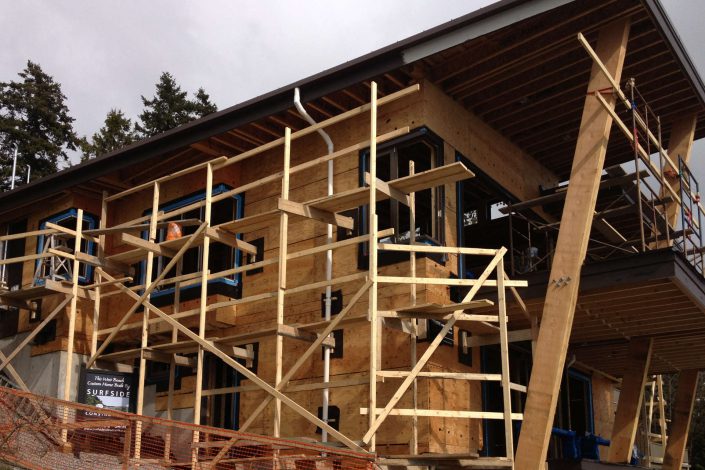 a photo of the west beach home in progress with scaffolding as built by surfside construction inc.