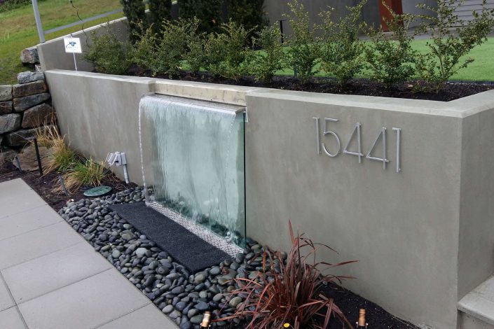 A photo of the unique waterfall planter built into the front of the hillside modern home in white rock bc as built by surfside construction inc.