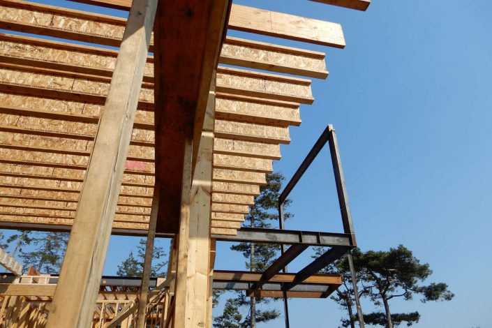 A shot of the floor joists being placed in the lighthouse home in the sooke bc as built by surfside construction inc.
