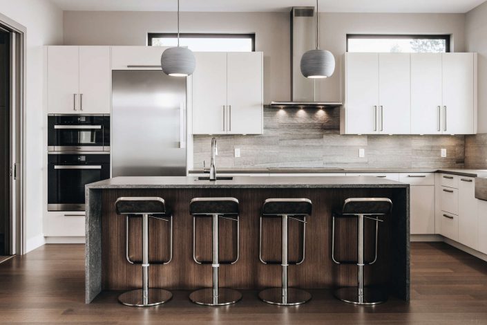 A photo of the kitchen and eating bar for the hillside modern home as built by surfside construction inc.