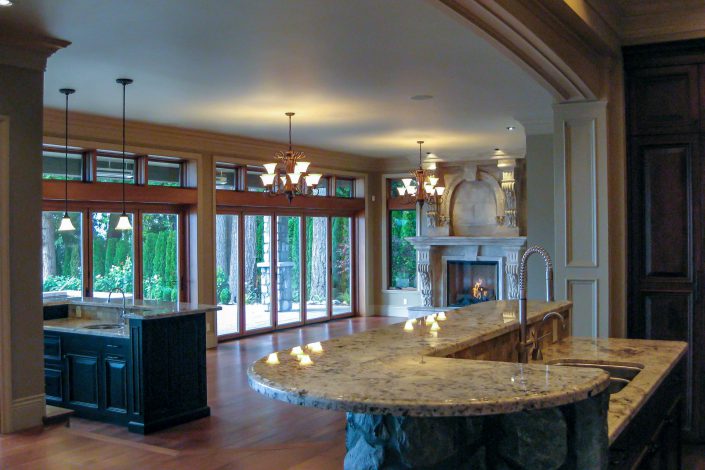 A photo taken from the hallway of the crescent bluff home showing the kitchen and the family room as built by surfside construction inc.