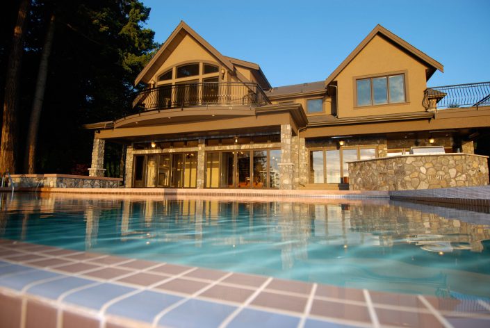 A photo of the back yard of the crescent bluff home showing the pool, and patio. as built by surfside construction inc.