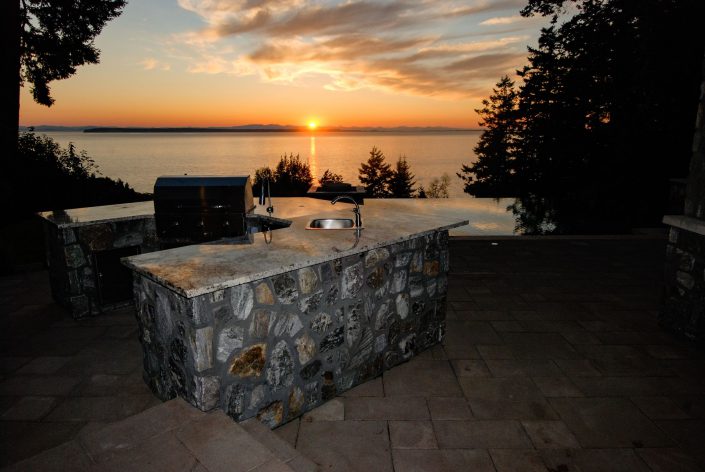 A photo of the built in barbecue and view of the ocean of the crescent bluff home as built by surfside construction inc.